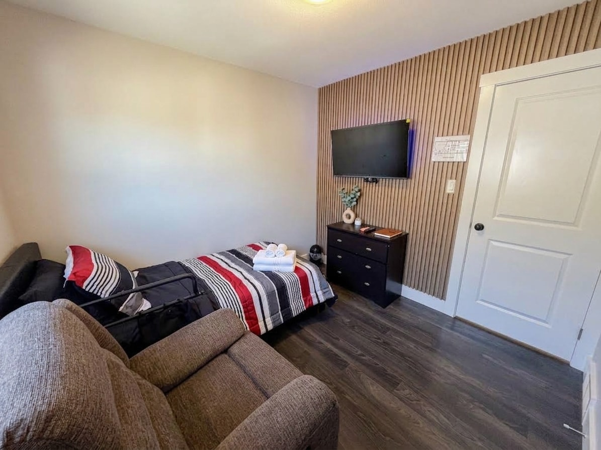 Bedroom with recliner and striped bedding